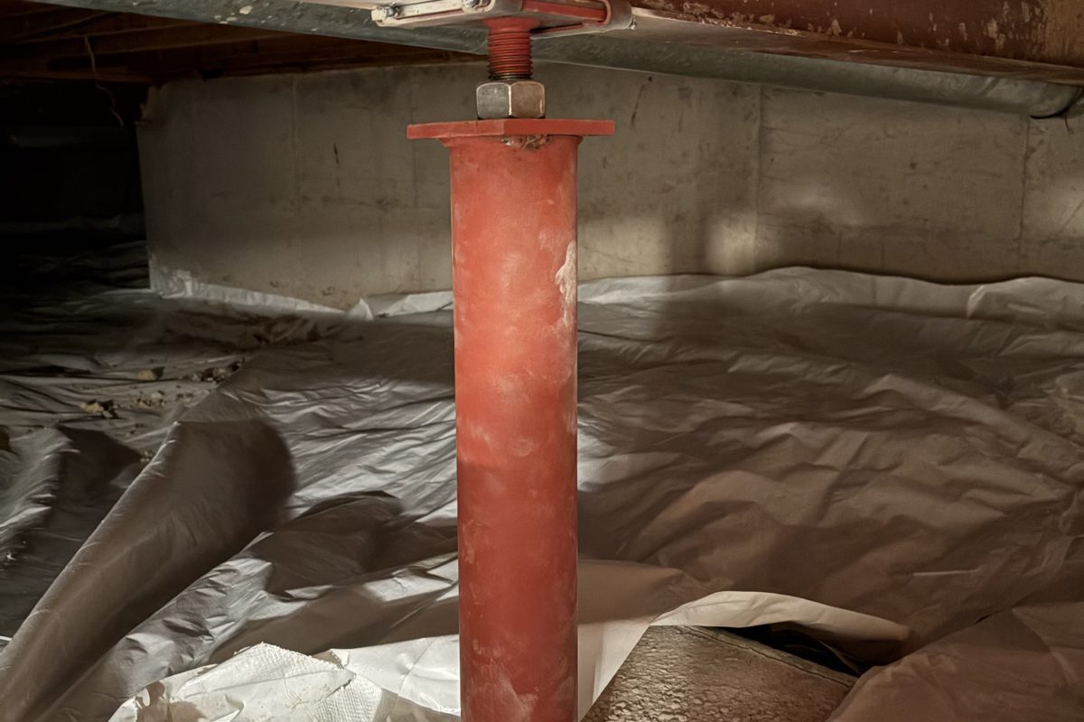 After: new red steel support post on a new footing under the main beam, Centennial
