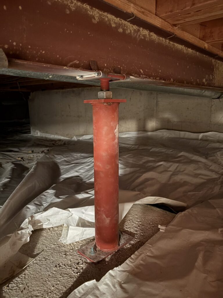 After: new red steel support post on a new footing under the main beam, Centennial