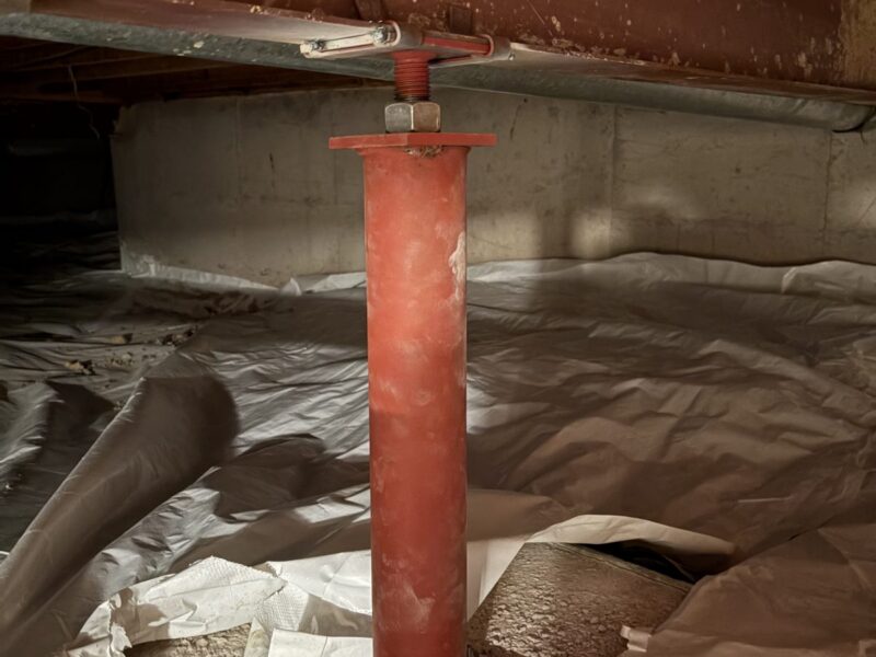 After: new red steel support post on a new footing under the main beam, Centennial