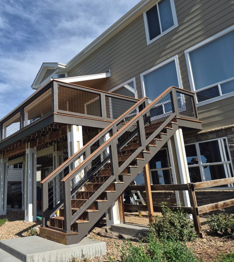 Two-story composite deck with hog-wire railing and matching stairs by Brimie Contractors
