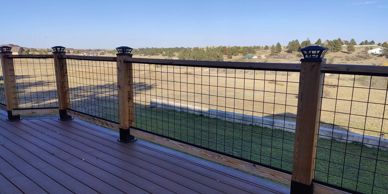 Composite deck with wood and hog-wire railing by Brimie Contractors