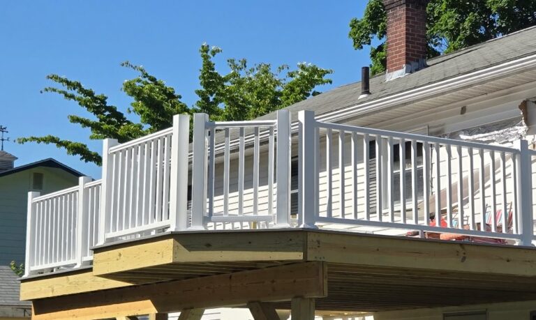 New second-story deck with white vinyl railing by Brimie Contractors