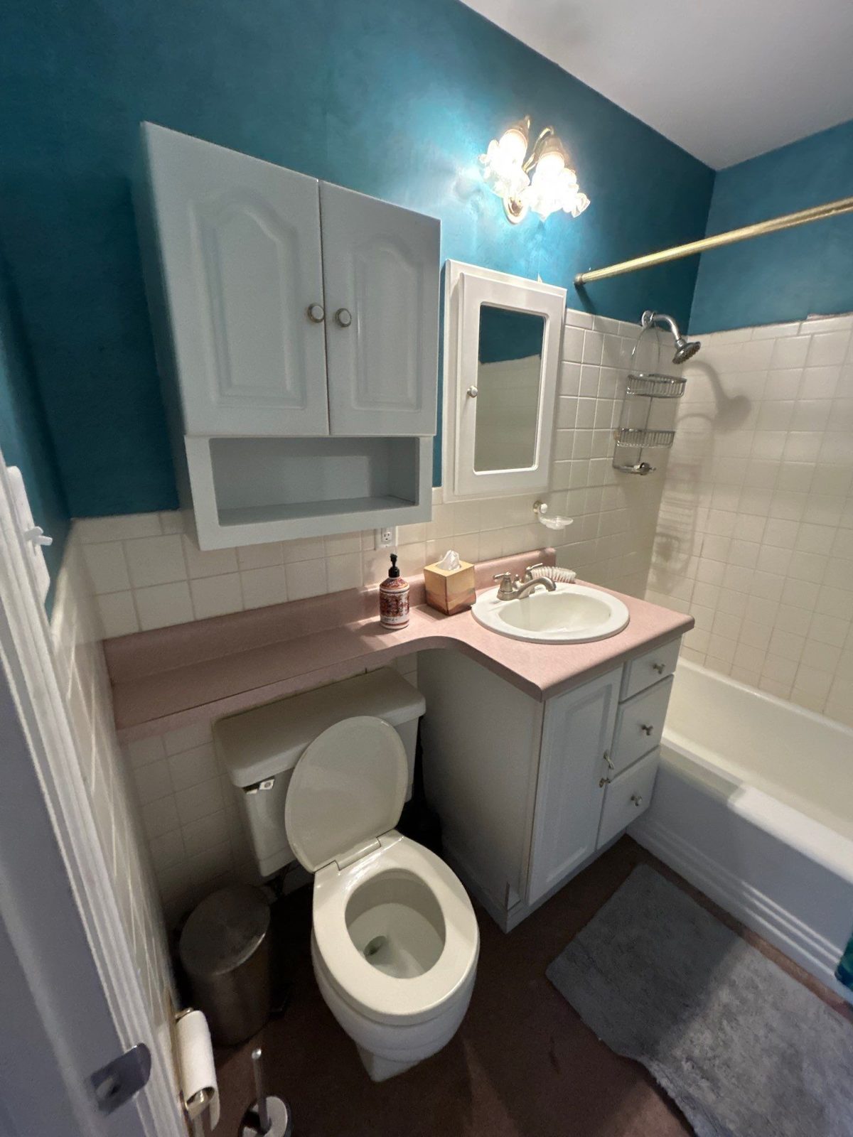 Before: dated bathroom with pink laminate vanity and teal walls, Denver