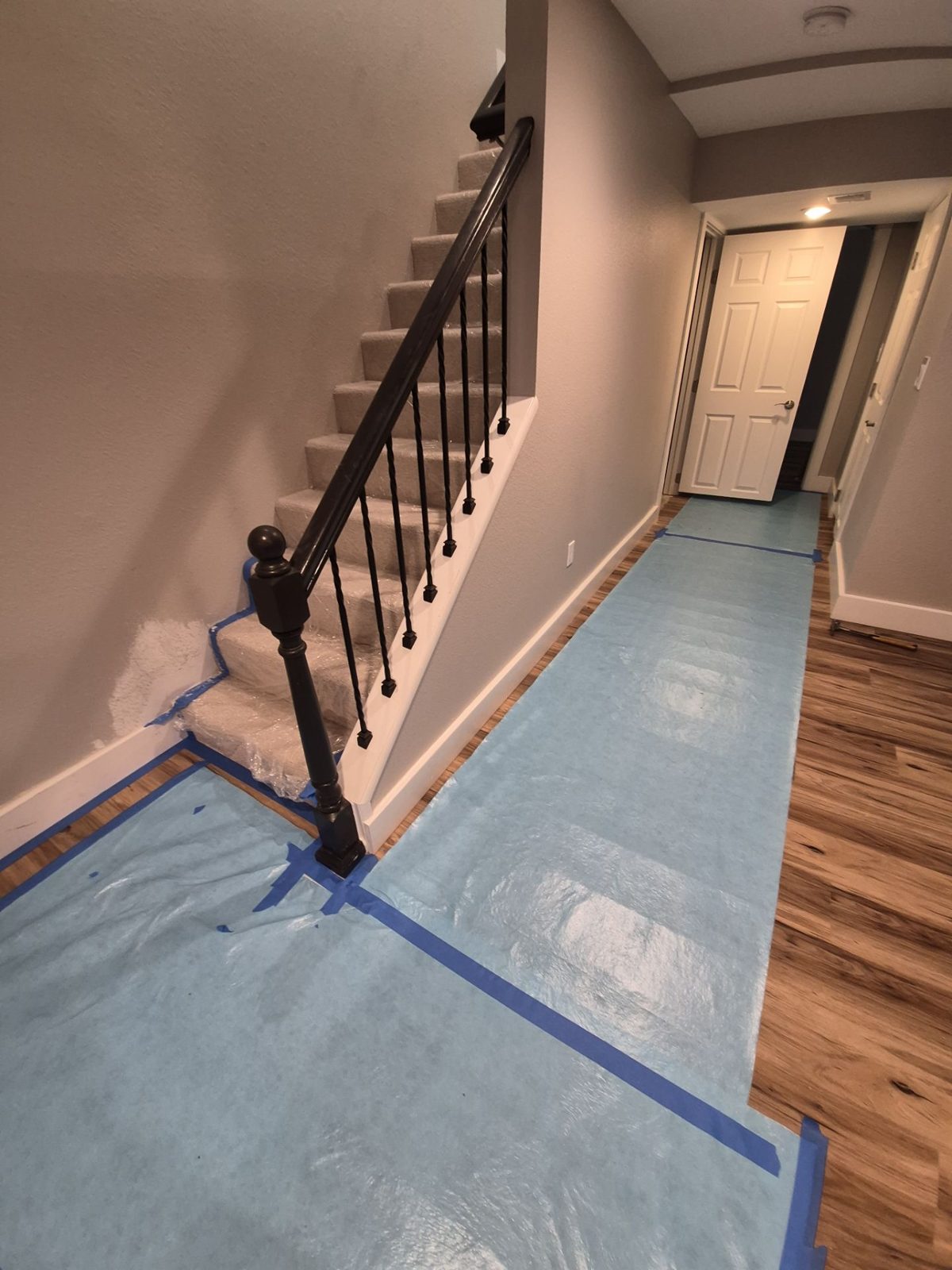Floor and stair protection laid before work inside an occupied home