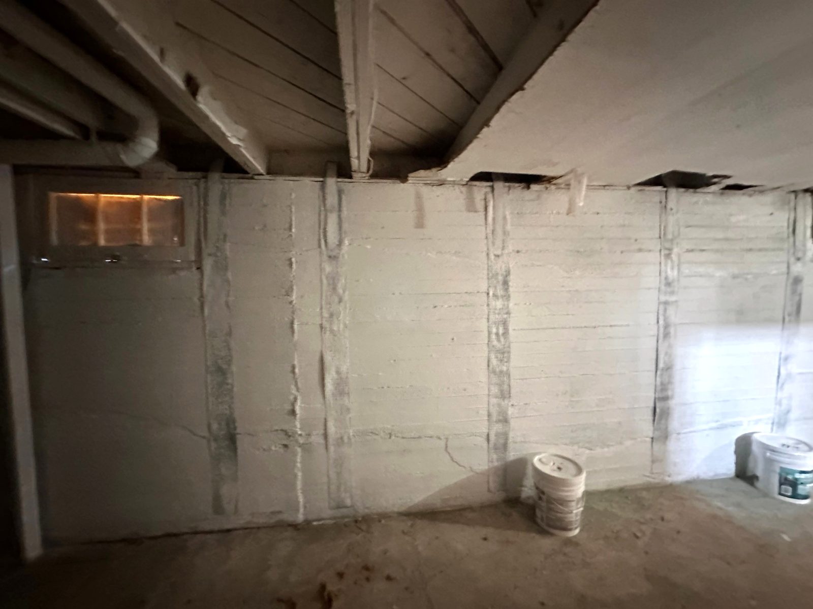 After: stitched foundation wall sealed and painted white, Fort Morgan