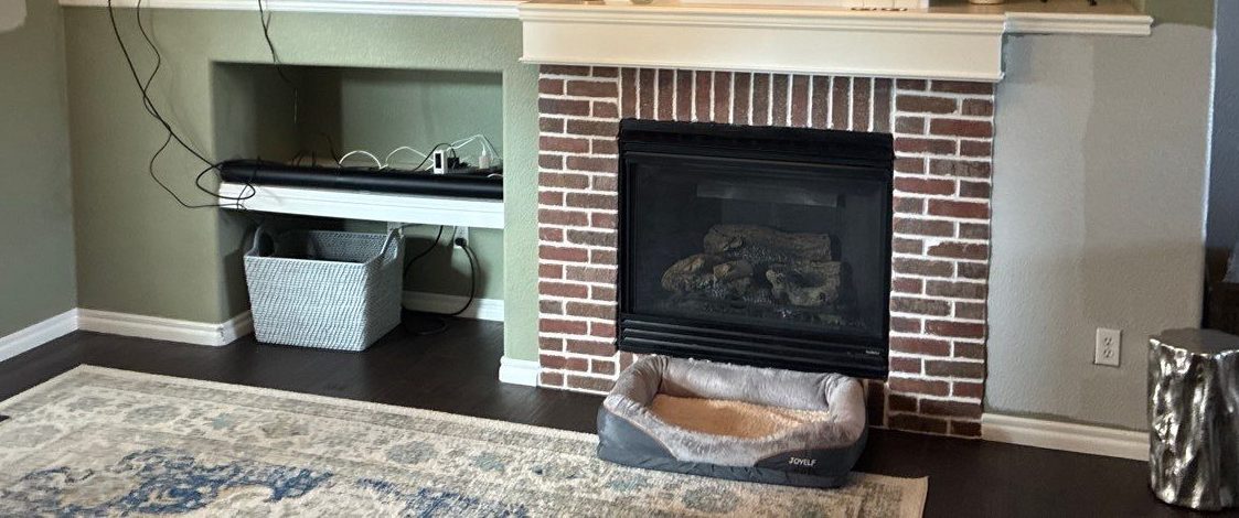 Before: brick fireplace with painted mantel and TV ledge, Highlands Ranch