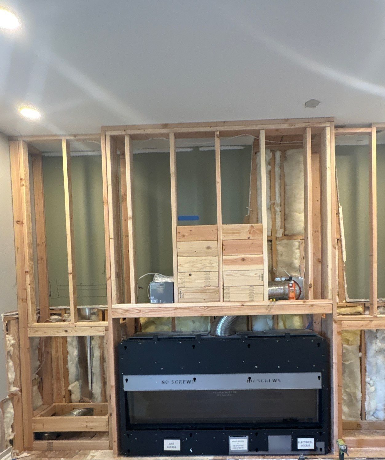 During: fireplace wall reframed around a new linear gas firebox, Highlands Ranch