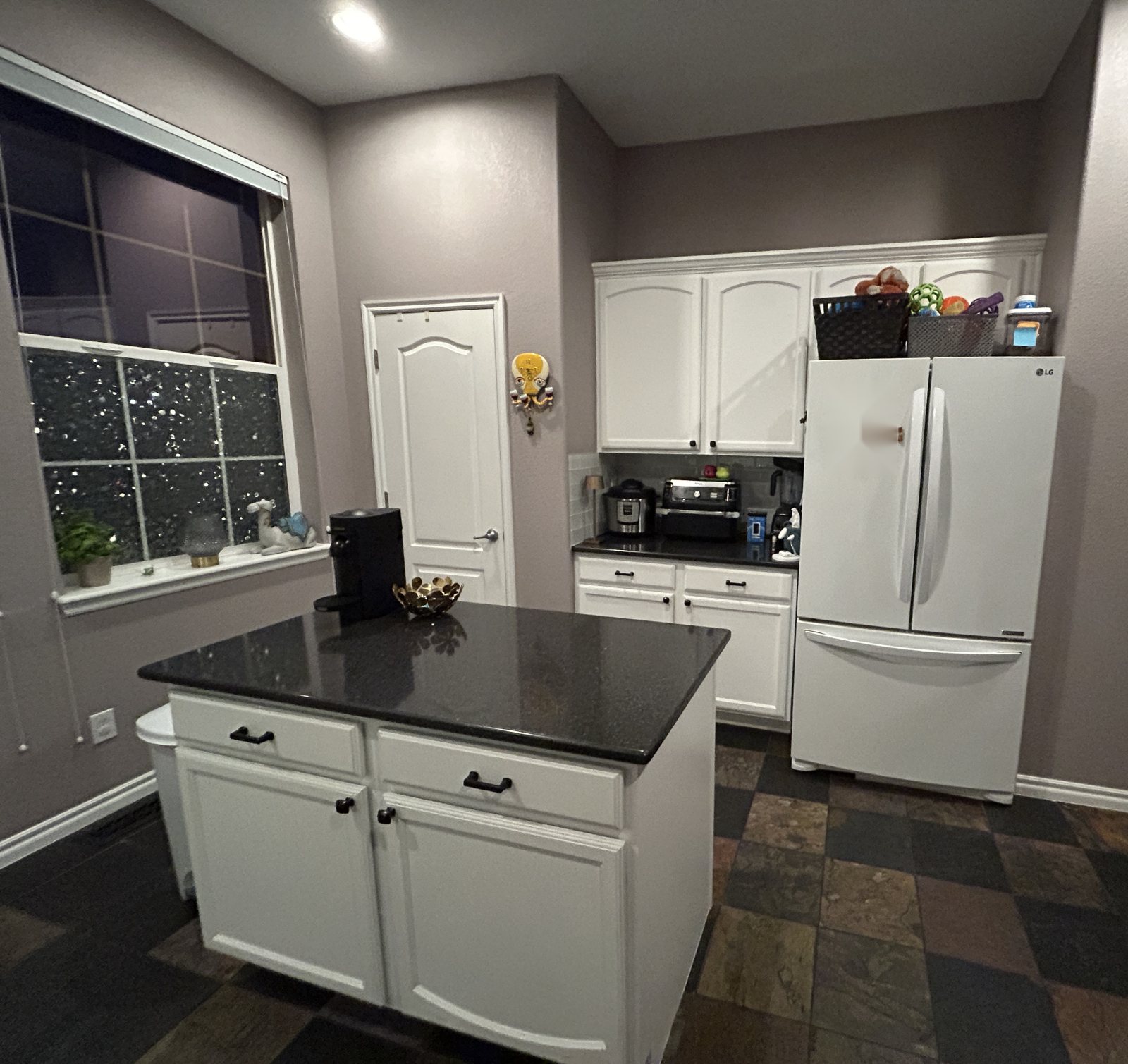 Before: Highlands Ranch kitchen island with black granite top, pantry wall and slate tile floor