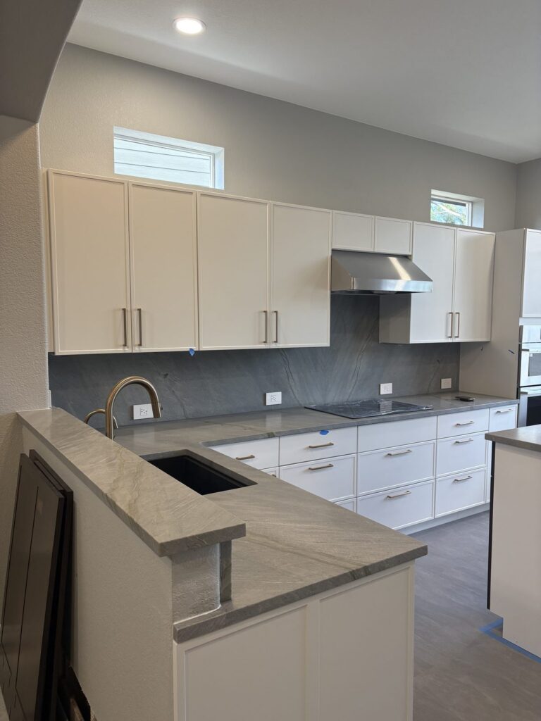 Highlands Ranch kitchen remodel with white cabinets and gray stone counters by Brimie Contractors