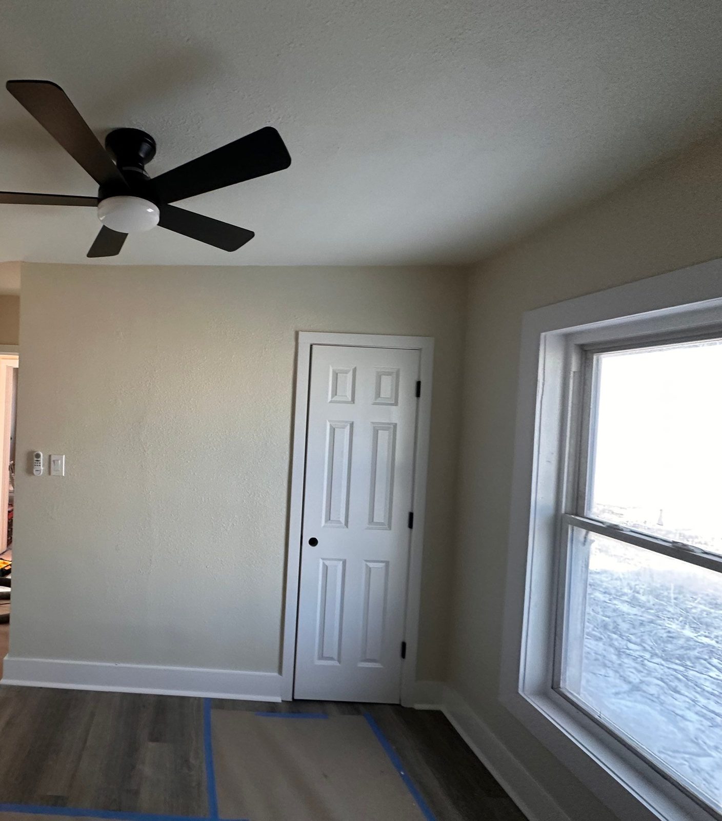 Investor rehab after: painted bedroom with new LVP flooring, trim and ceiling fan, Fort Morgan