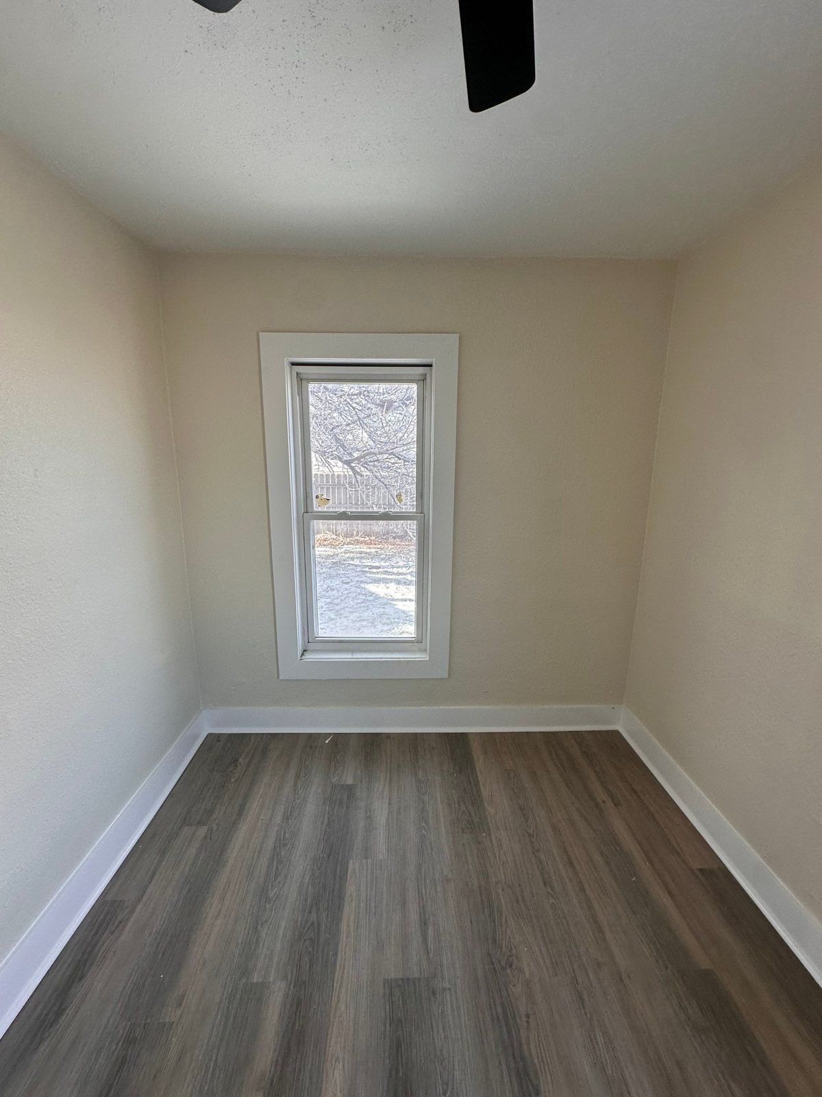 Investor rehab after: finished bedroom with new LVP flooring and fresh paint, Fort Morgan