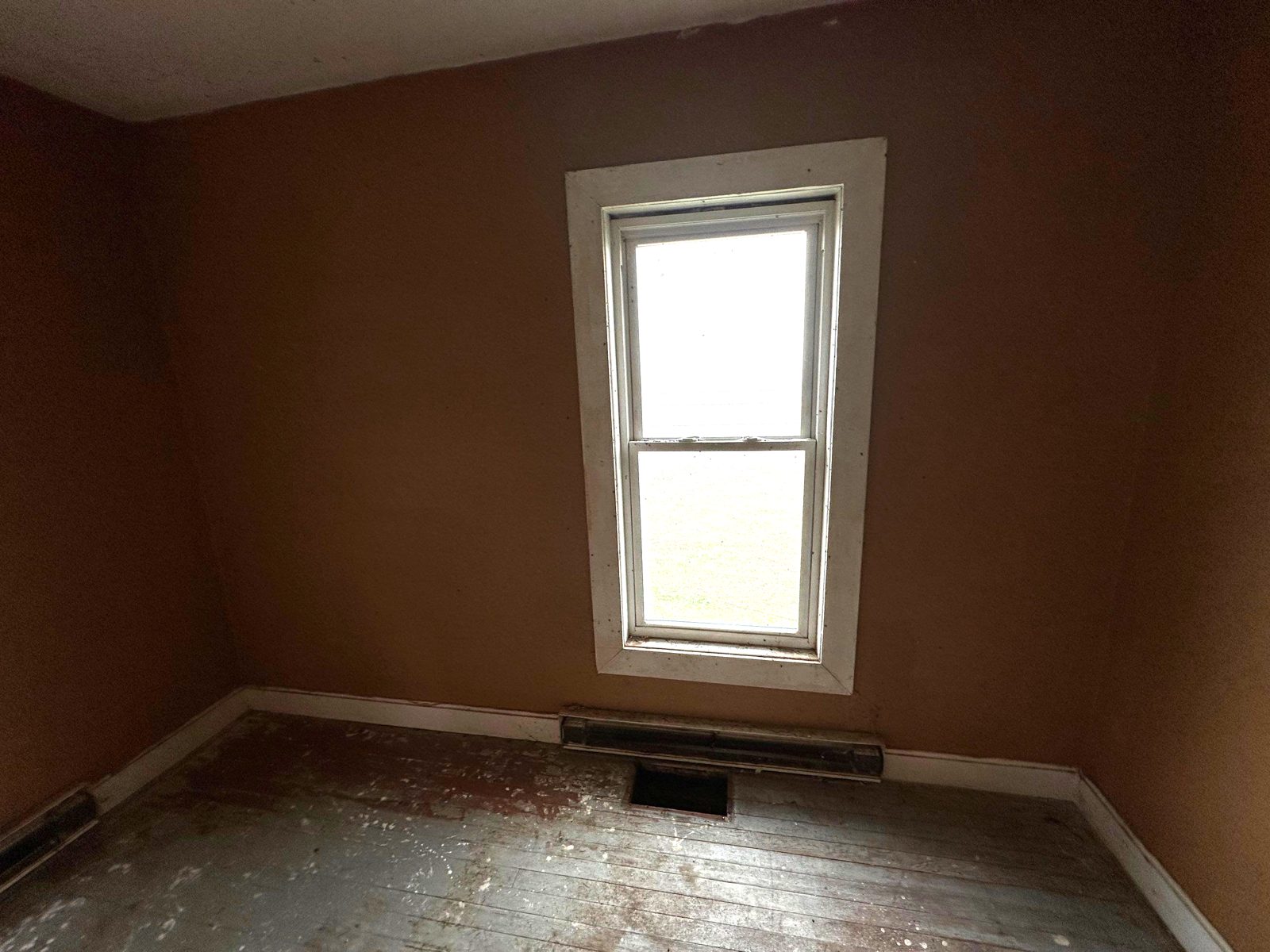 Before: dark bedroom with worn painted floor, Fort Morgan