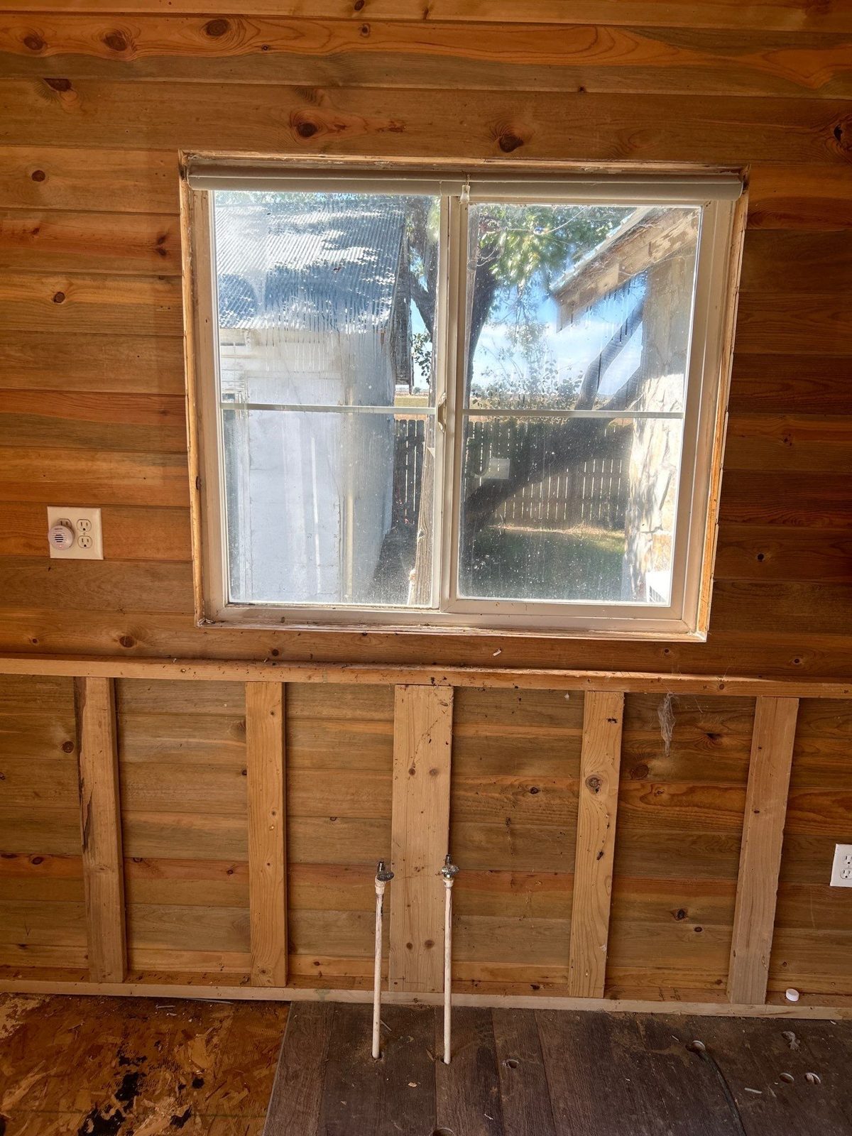 Before: kitchen wall opened to studs and plumbing stub-outs, Fort Morgan