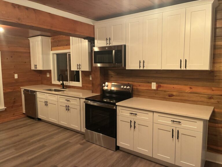 Kitchen remodel with white cabinets, quartz counters and cedar plank walls by Brimie Contractors