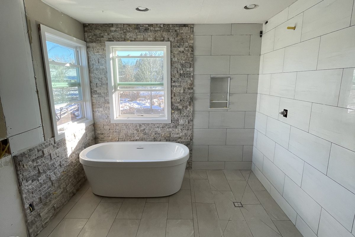 Parker bathroom remodel with freestanding tub and stone accent wall by Brimie Contractors