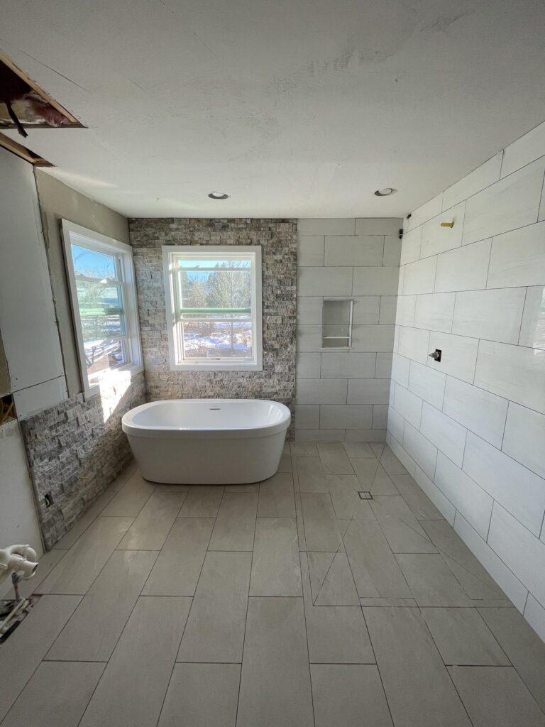 Parker bathroom remodel with freestanding tub and stone accent wall by Brimie Contractors