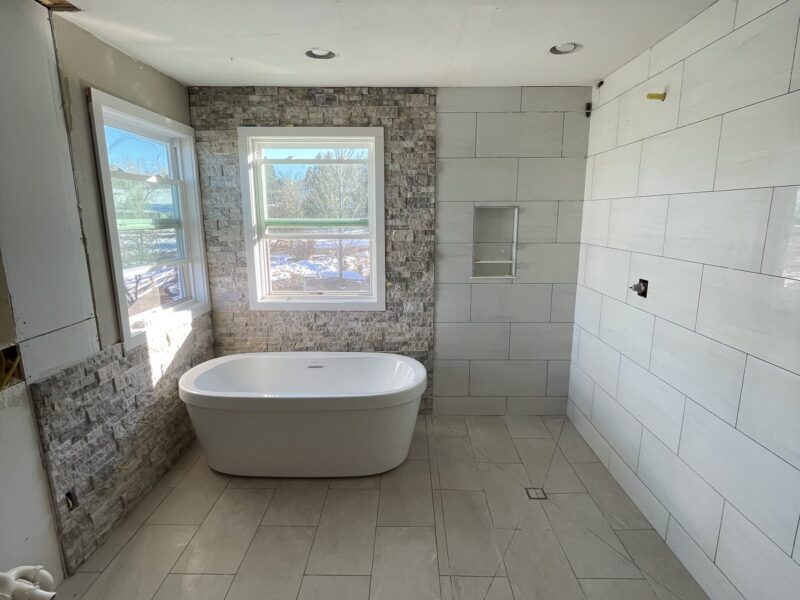 Parker bathroom remodel with freestanding tub and stone accent wall by Brimie Contractors