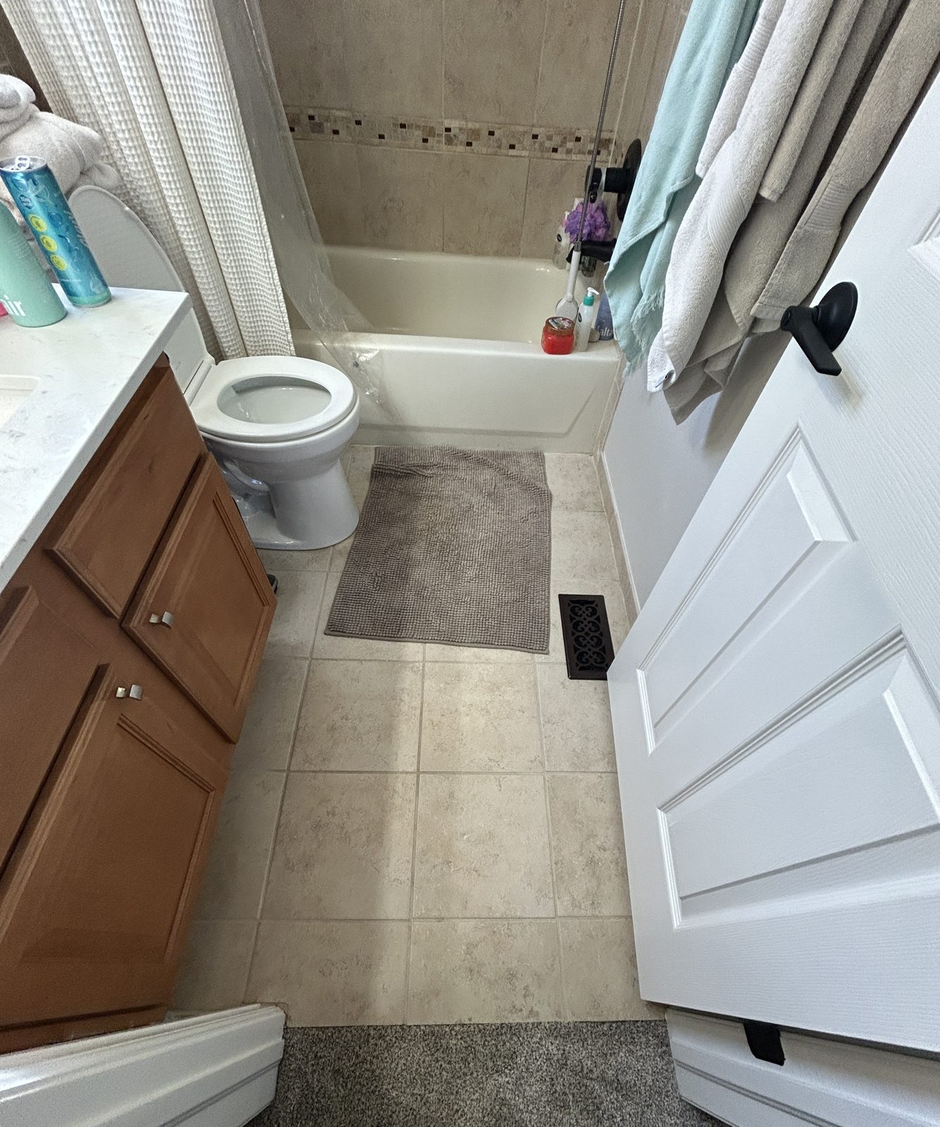 Before: Parker hall bathroom with beige ceramic floor tile