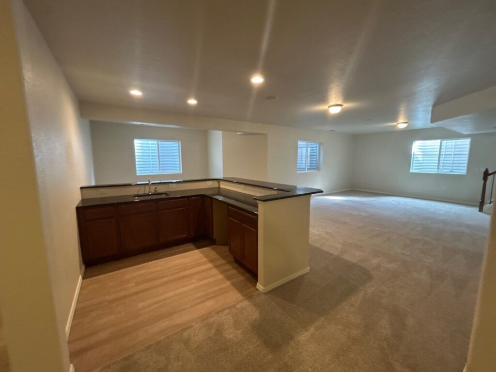 After: basement kitchenette with countertop repair and fresh paint