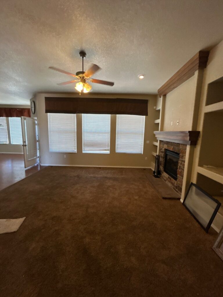 Before: great room with dated paint and heavy window valance