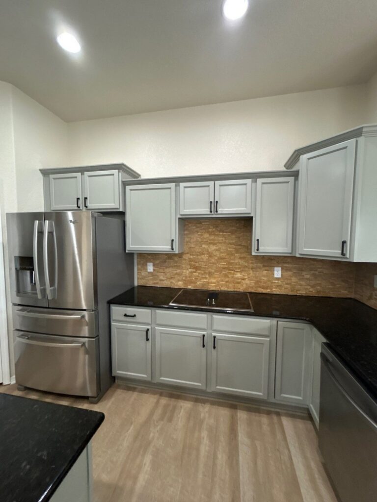After: kitchen range wall with painted gray cabinets and new hardware