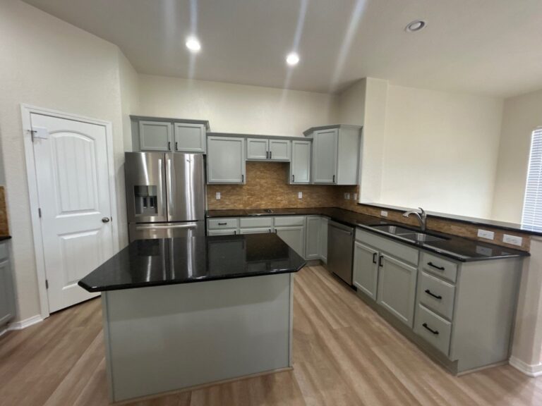 After: kitchen with cabinets painted Escape Gray, new black pulls, Peyton investor make-ready