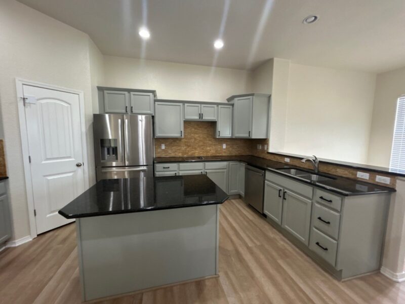 After: kitchen with cabinets painted Escape Gray, new black pulls, Peyton investor make-ready