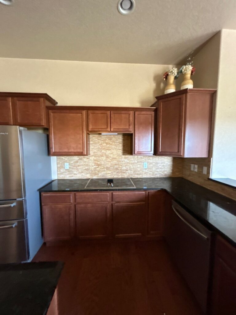 Before: kitchen range wall with cherry cabinets