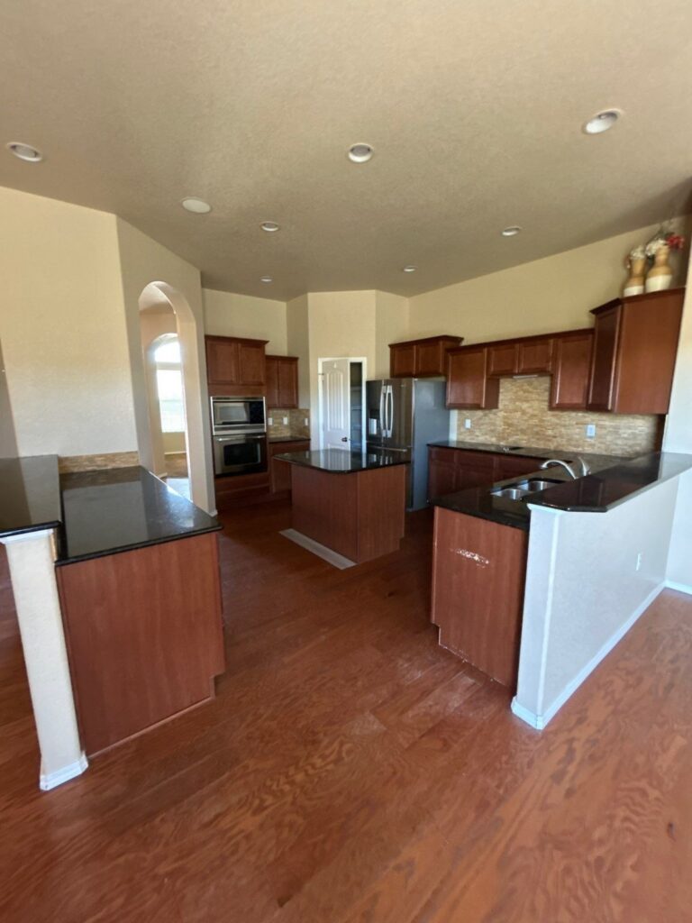 Before: kitchen with dated cherry cabinets, Peyton investor make-ready