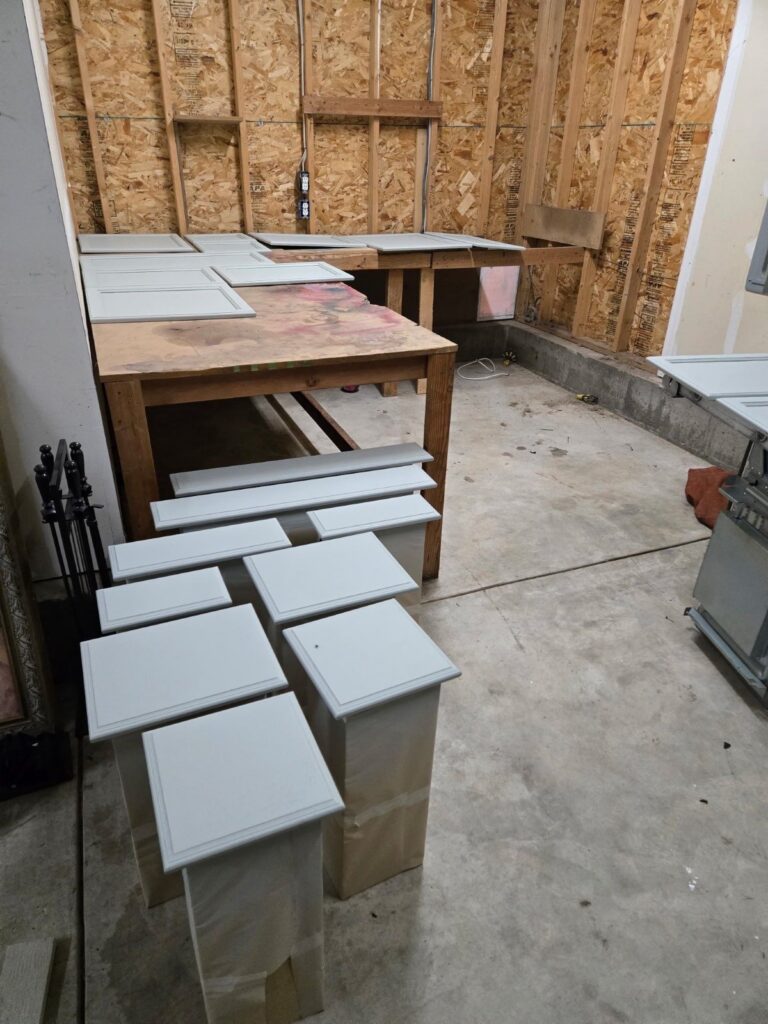 During: kitchen cabinet doors primed and painted off-site in the garage