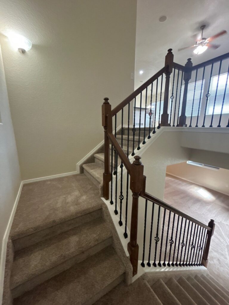 After: staircase with repaired handrails and fresh paint