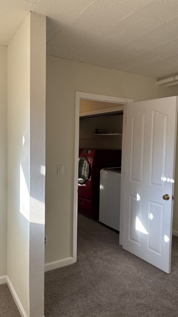 After presale repair, Parker basement room: blue wallpaper and stained carpet replaced with paint and new carpet